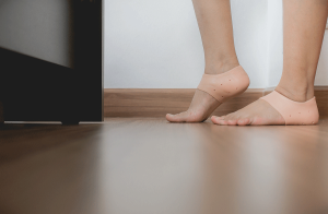woman wearing foot supports for relief from plantar fasciitis